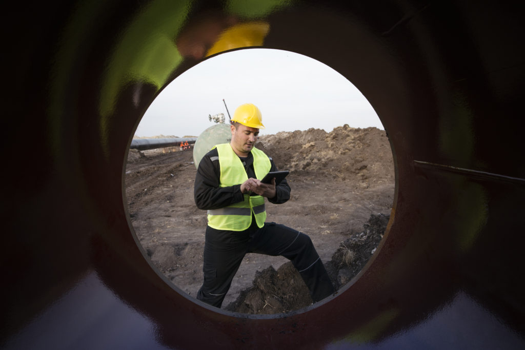 shot-oilfield-worker-checking-quality-gas-pipes-construction-site.jpg